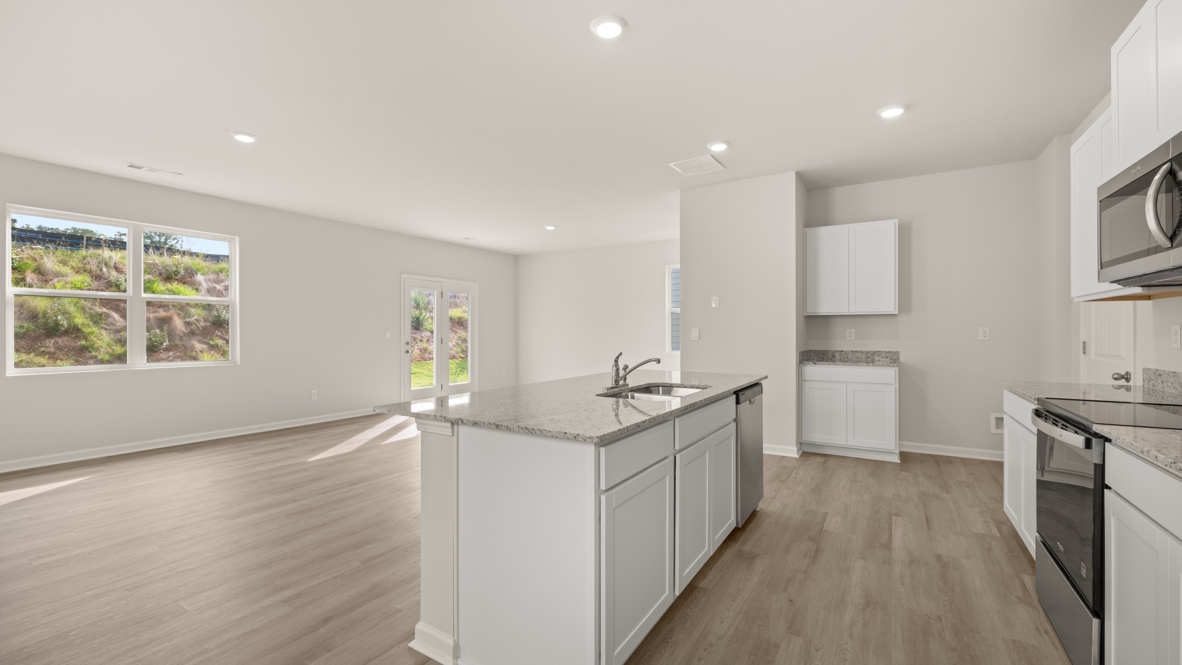 Interior kitchen with center isladn and white cabinets