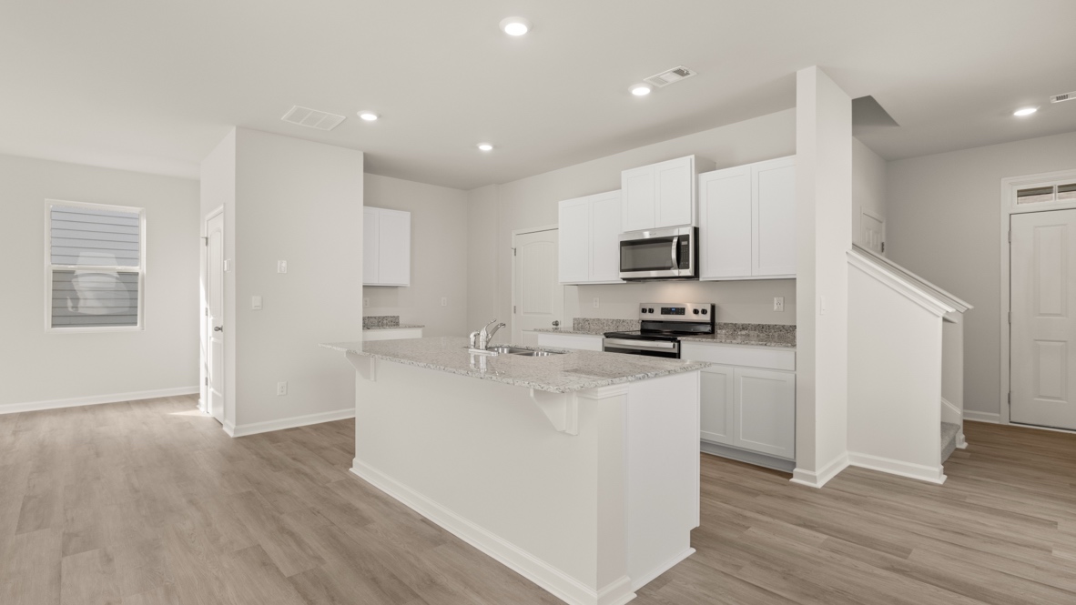 Interior kitchen with center isladn and white cabinets