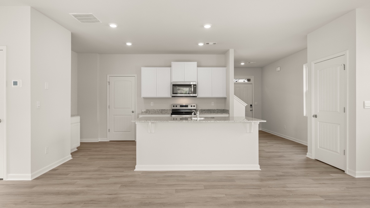 Interior kitchen with center isladn and white cabinets