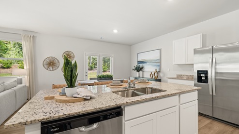 Interior kitchen with center island open to dining area