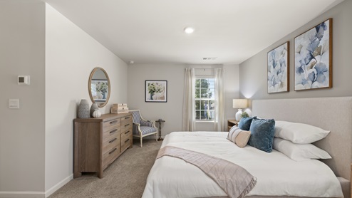 Interior primary bedroom with large windows