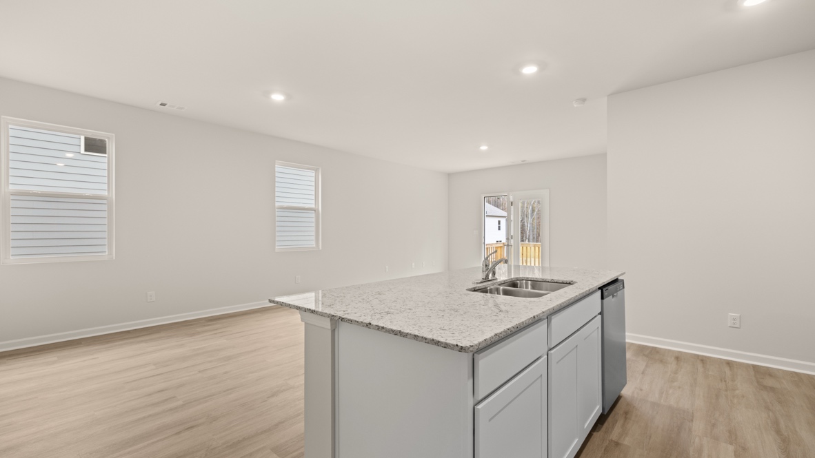 Interior kitchen with center island and white cabinets