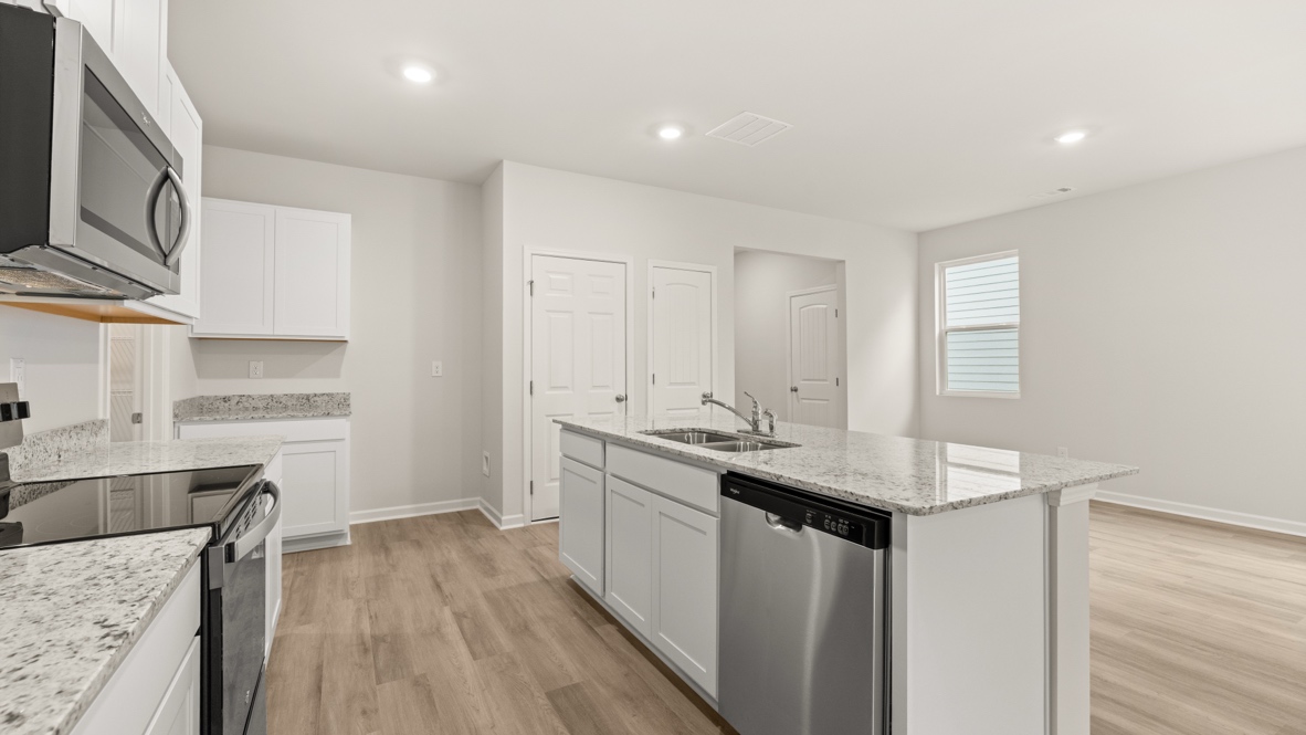 Interior kitchen with center island and white cabinets
