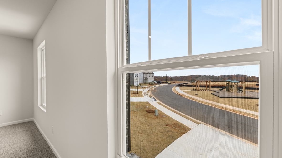 Interior primary bedroom with large windows