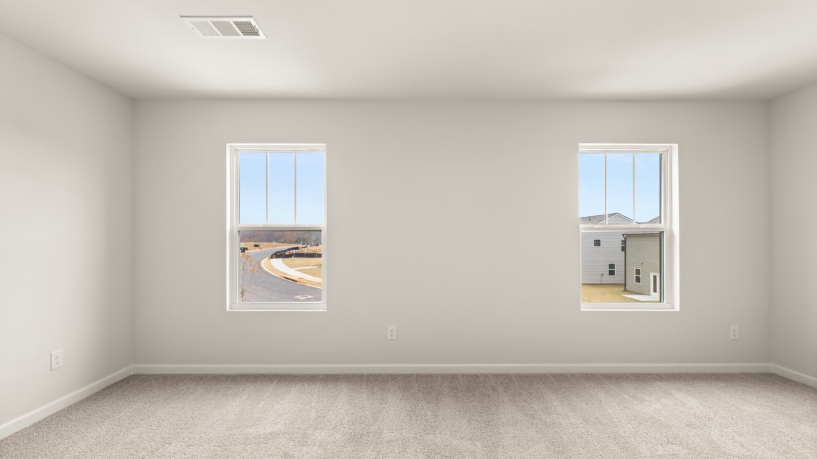 Interior primary bedroom with large windows