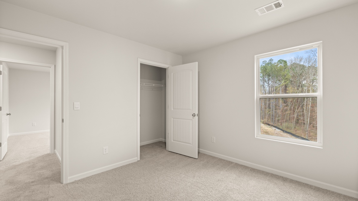 Interior bedroom with window and closet