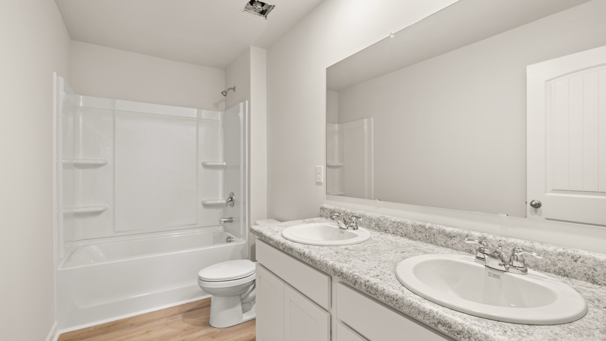 Interior bathroom with double sink and full-sized shower