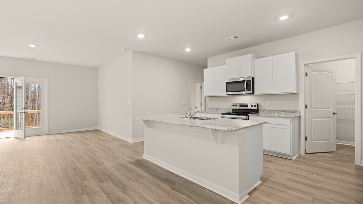 Interior kitchen with center island and white cabinets