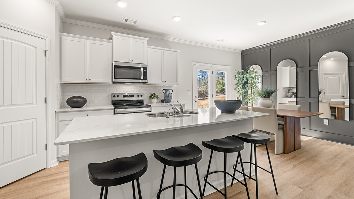 Interior kitchen with center island and white cabinets