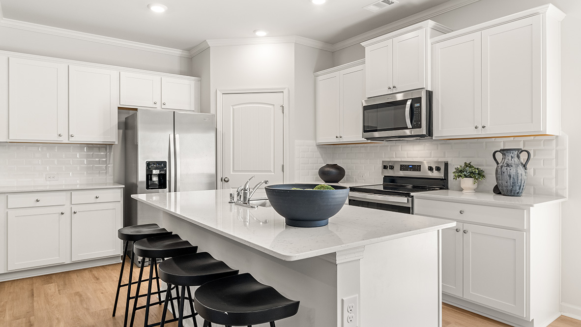 Interior kitchen with center island and white cabinets