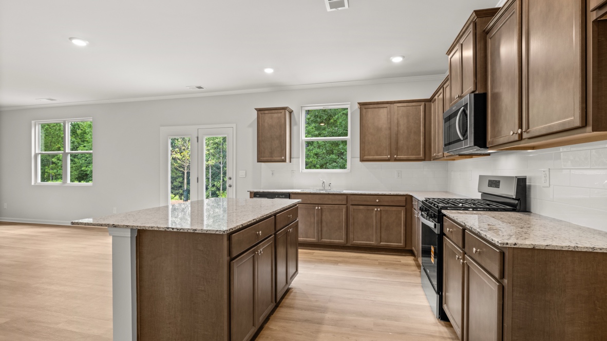Interior kitchen with center island and wooden cabinets