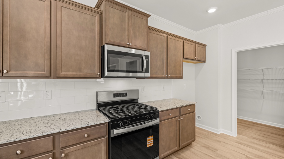 Interior kitchen with center island and wooden cabinets