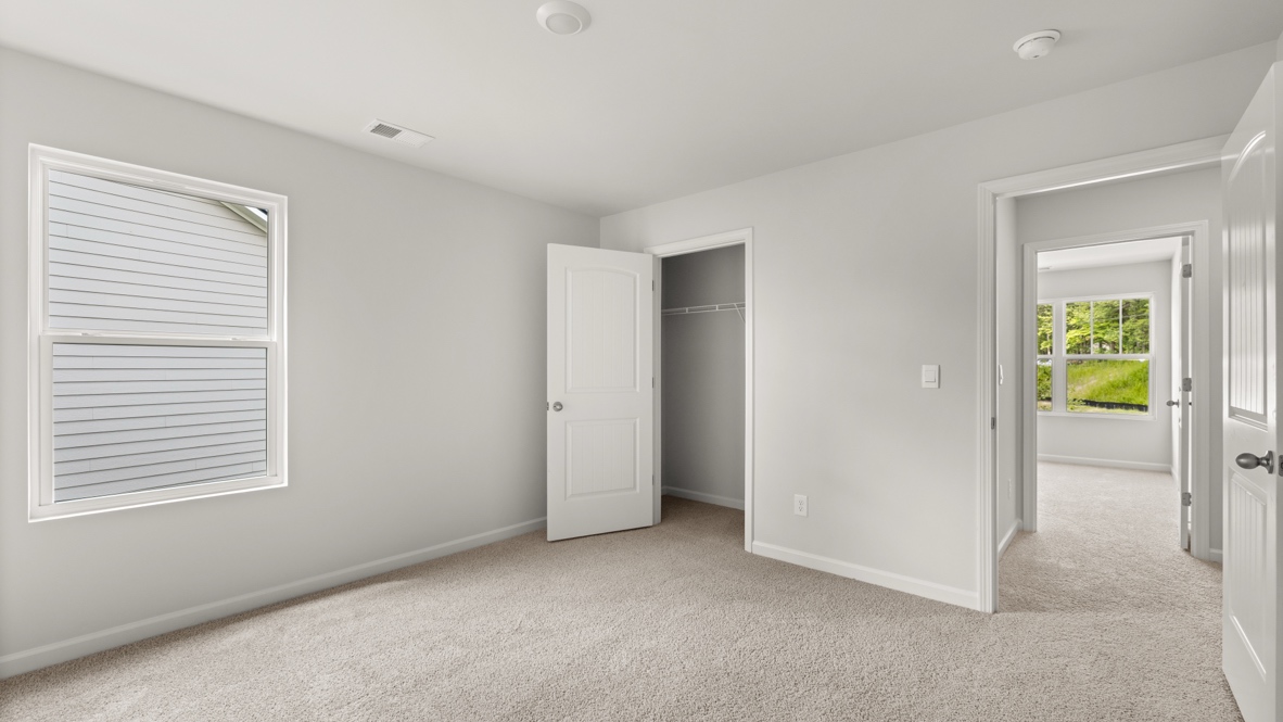 Interior bedroom with large window and closet