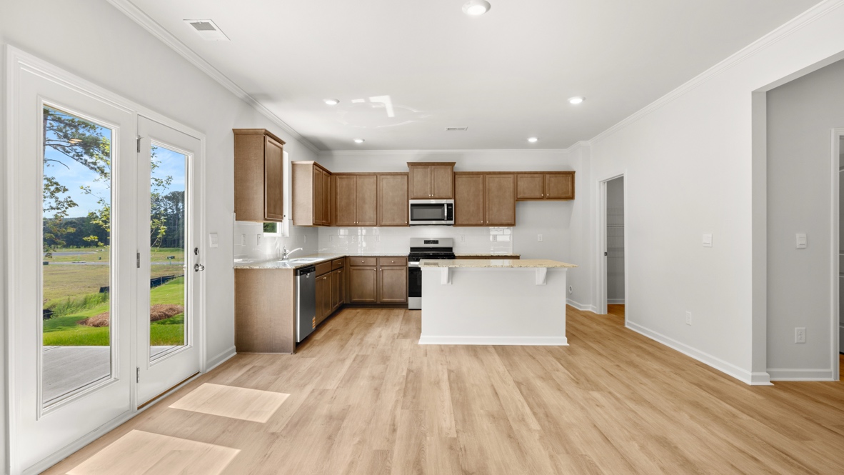 kitchen with brown cabinetry, large island and stainless steel appliances