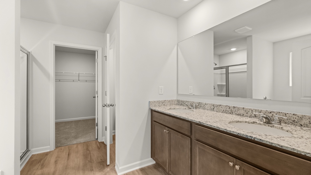 bathroom with a vanity sink, toilet and shower