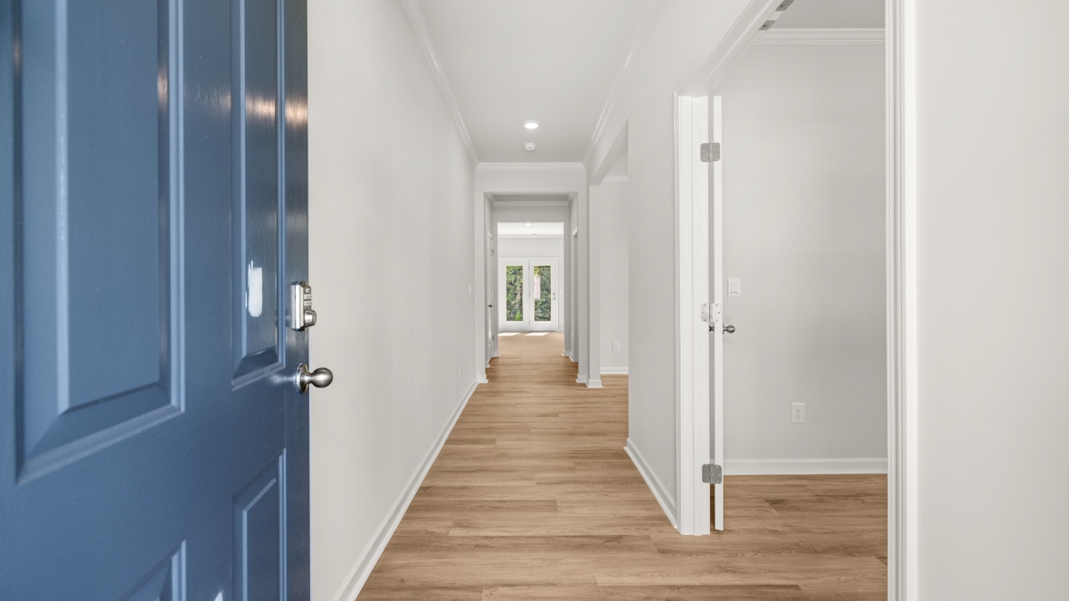 front entry way of home featuring brown flooring and white walls