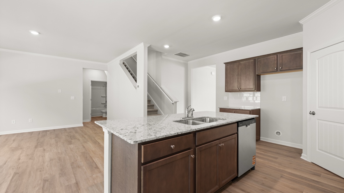 kitchen with brown cabinetry, large island and stainless steel appliances