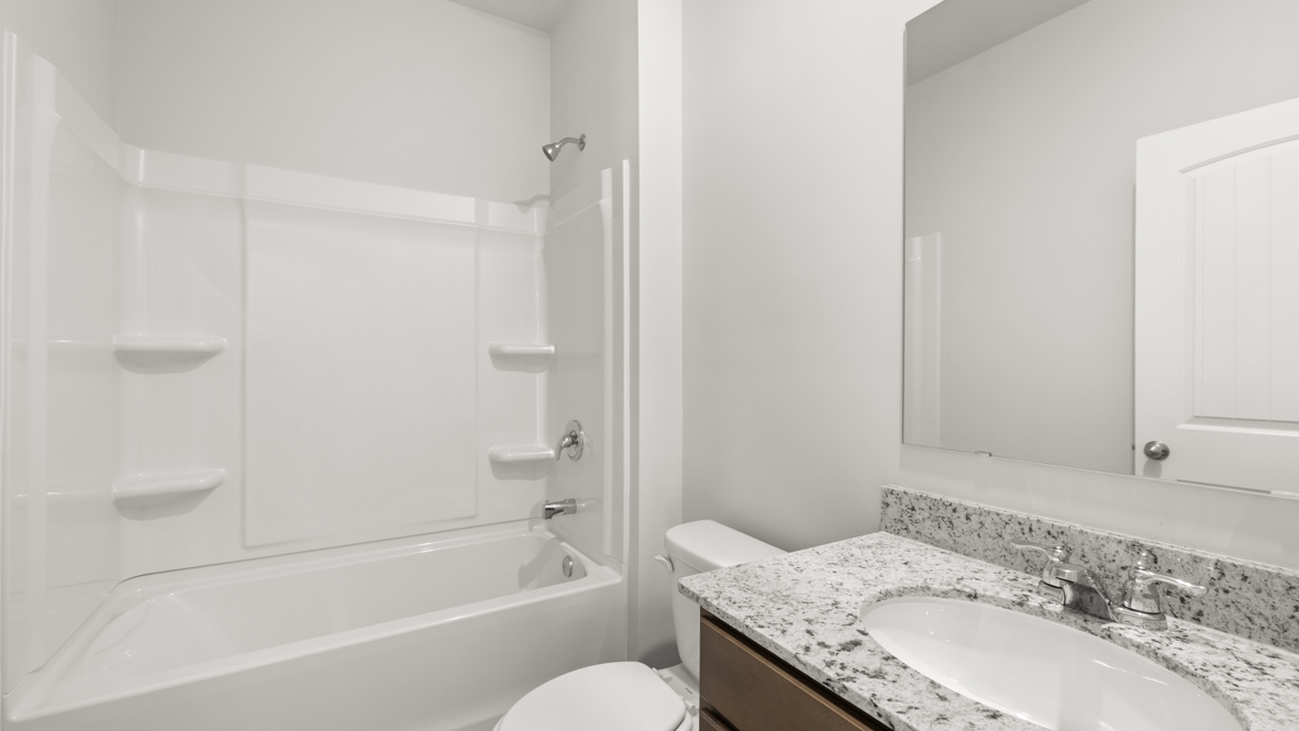 bathroom with a vanity sink, toilet and shower