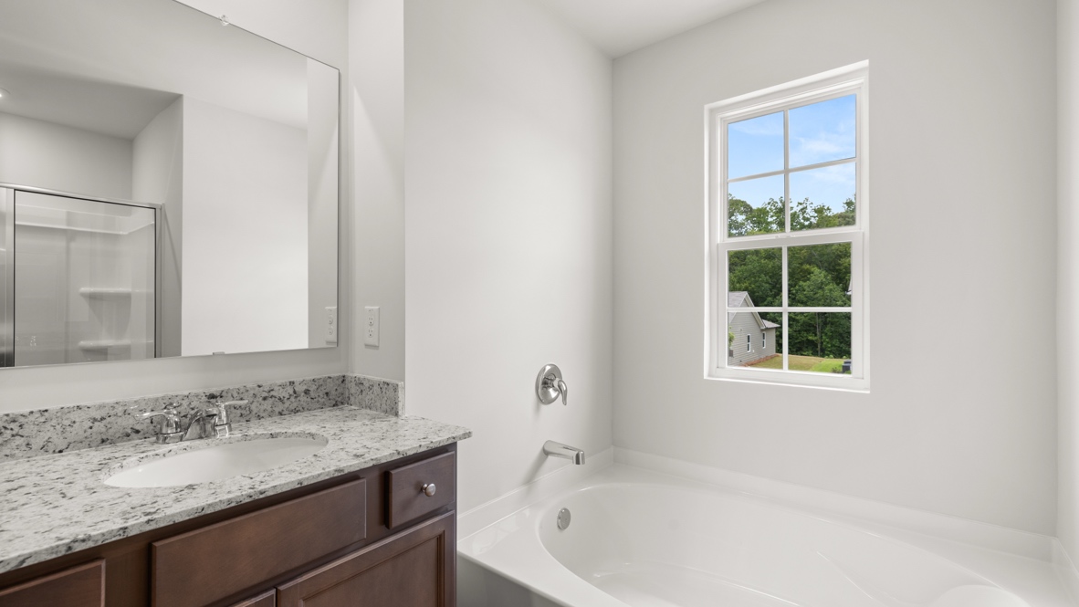 bathroom with a vanity sink, toilet and shower
