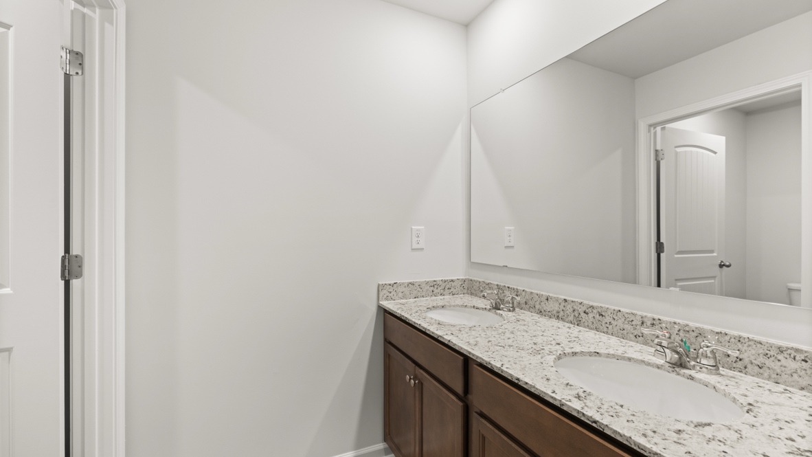 bathroom with a vanity sink, toilet and shower