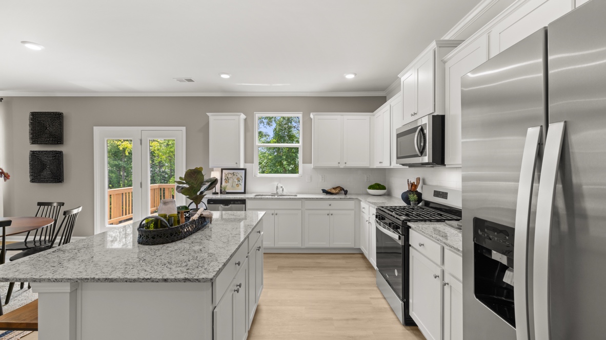 kitchen with white cabinetry, large island, and stainless steel appliances
