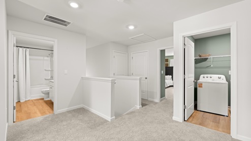 flex area with beige carpet, white walls and a window