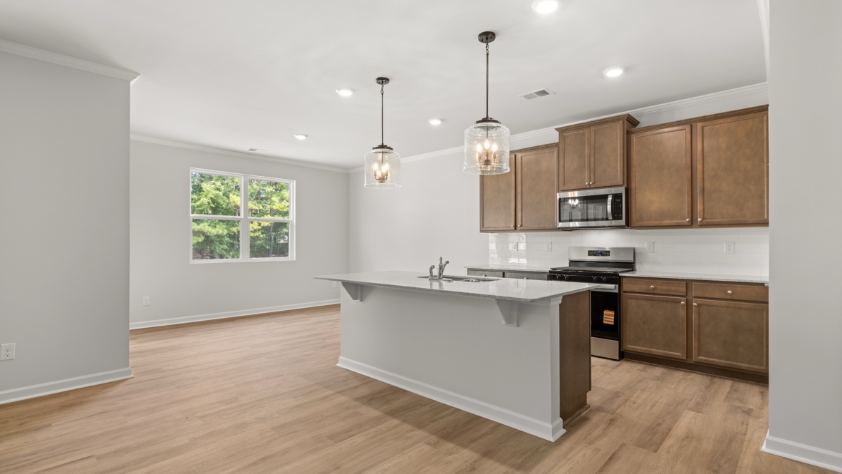 Interior kitchen with center island and wooden cabinets