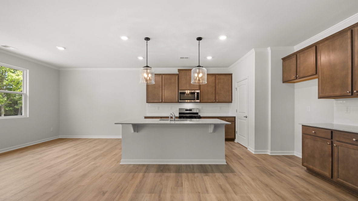 Interior kitchen with center island and wooden cabinets