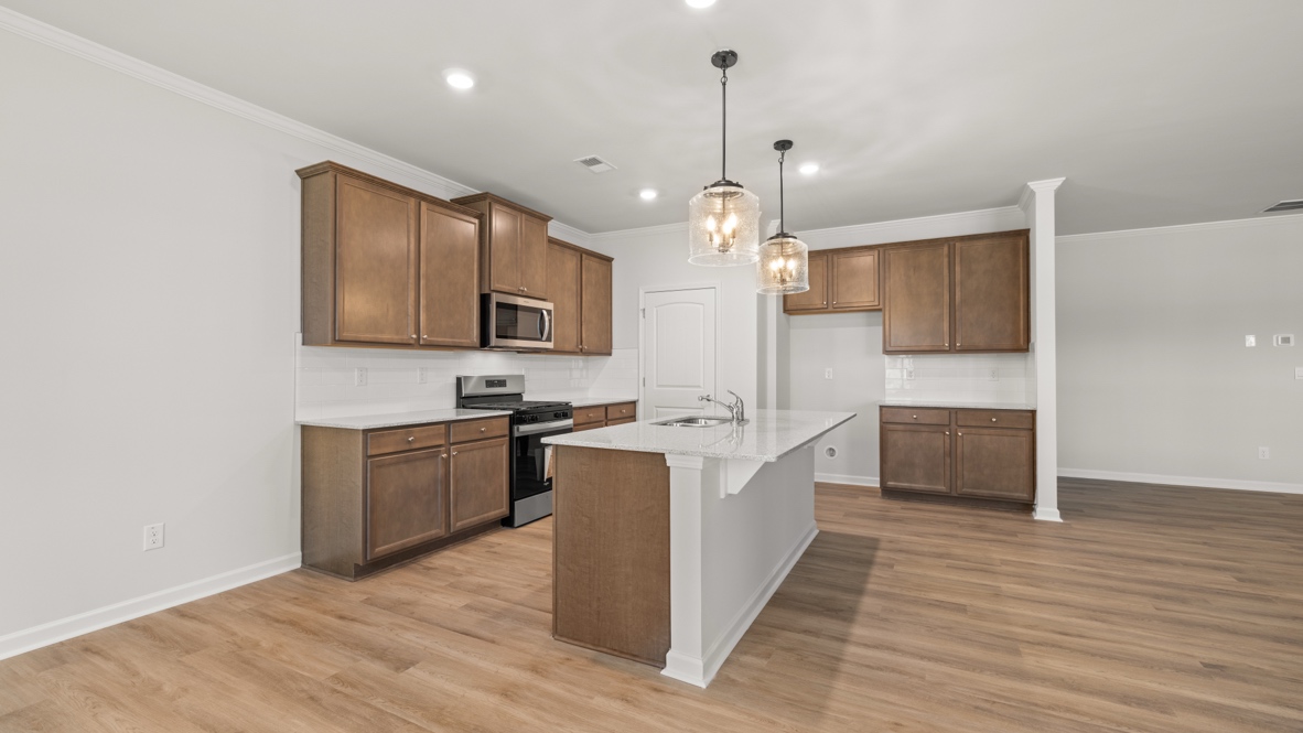 Interior kitchen with center island and wooden cabinets