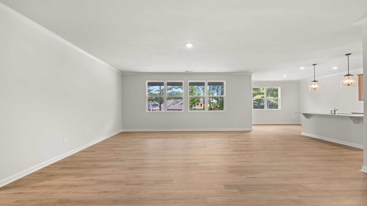 Interior living area with large windows and open to kitchen