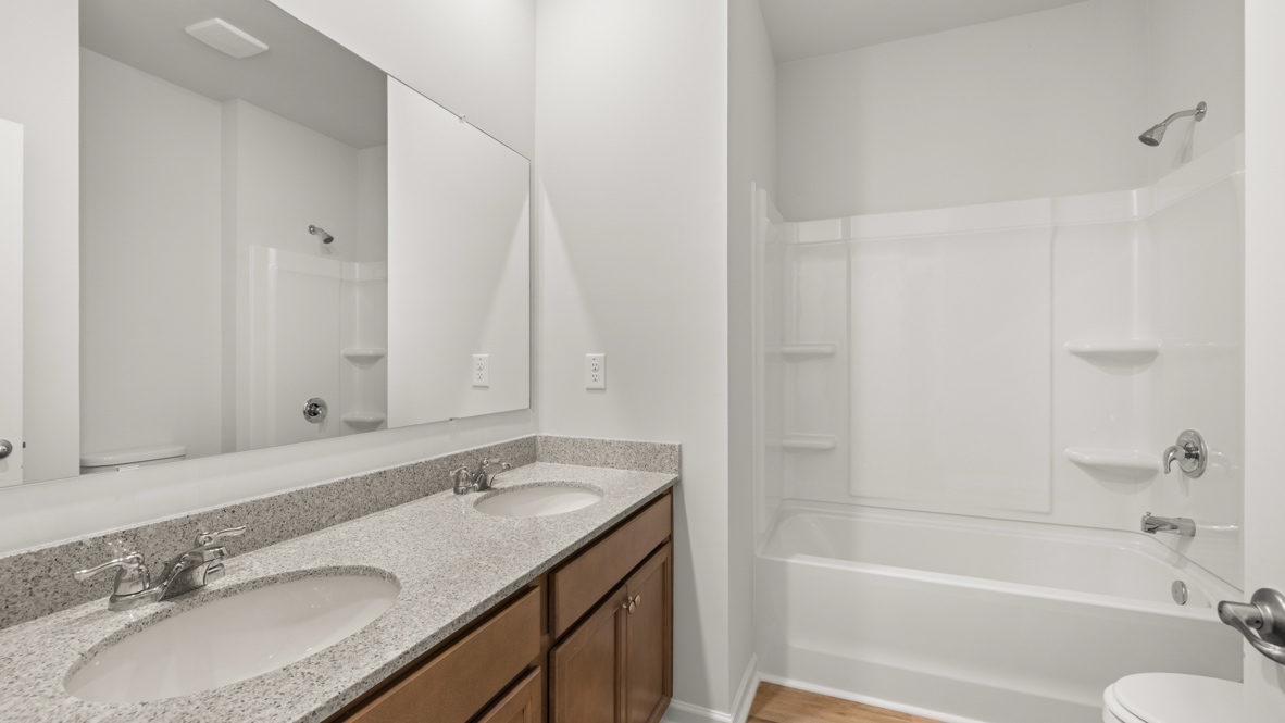 Interior bathroom with double sink and full-sized shower