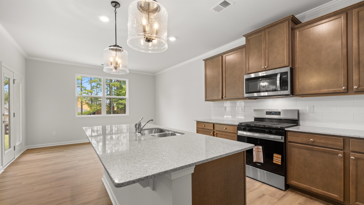 Interior kitchen with center island and wooden cabinets