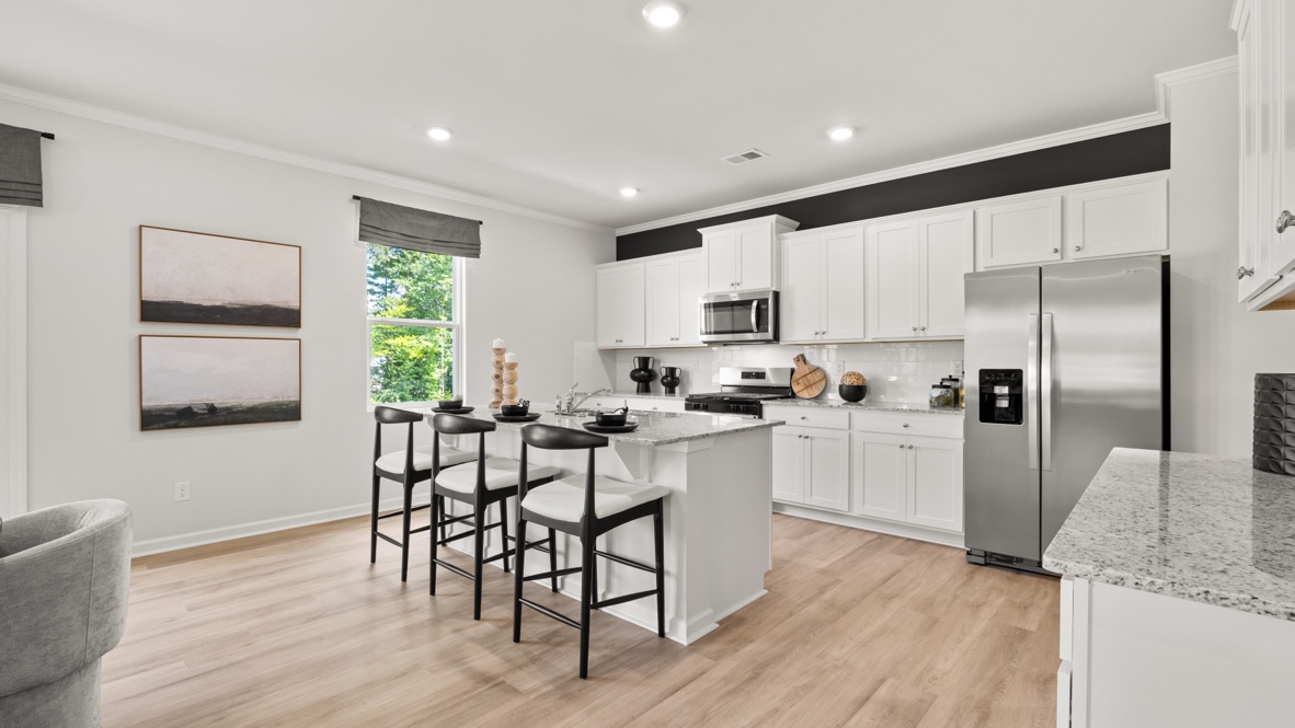 Interior kitchen with center island and white cabinets