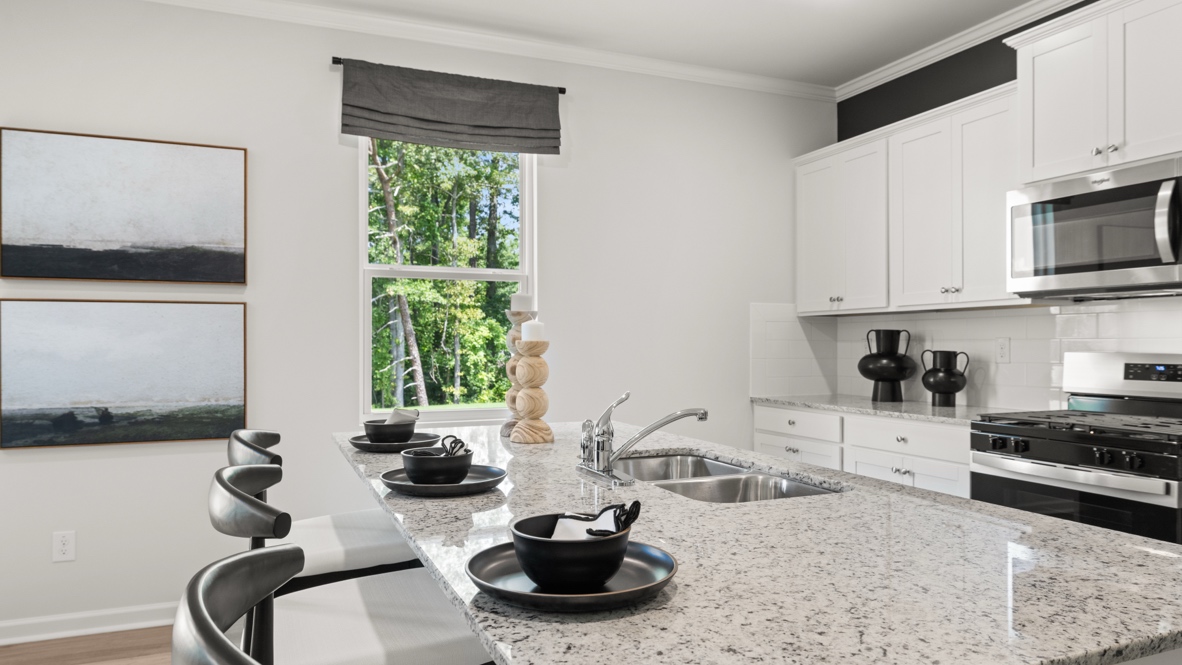 Interior kitchen with center island and white cabinets