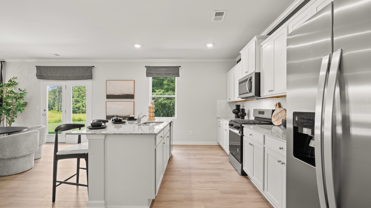Interior kitchen with center island and white cabinets