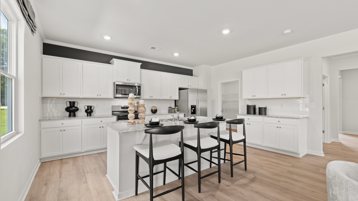 Interior kitchen with center island and white cabinets