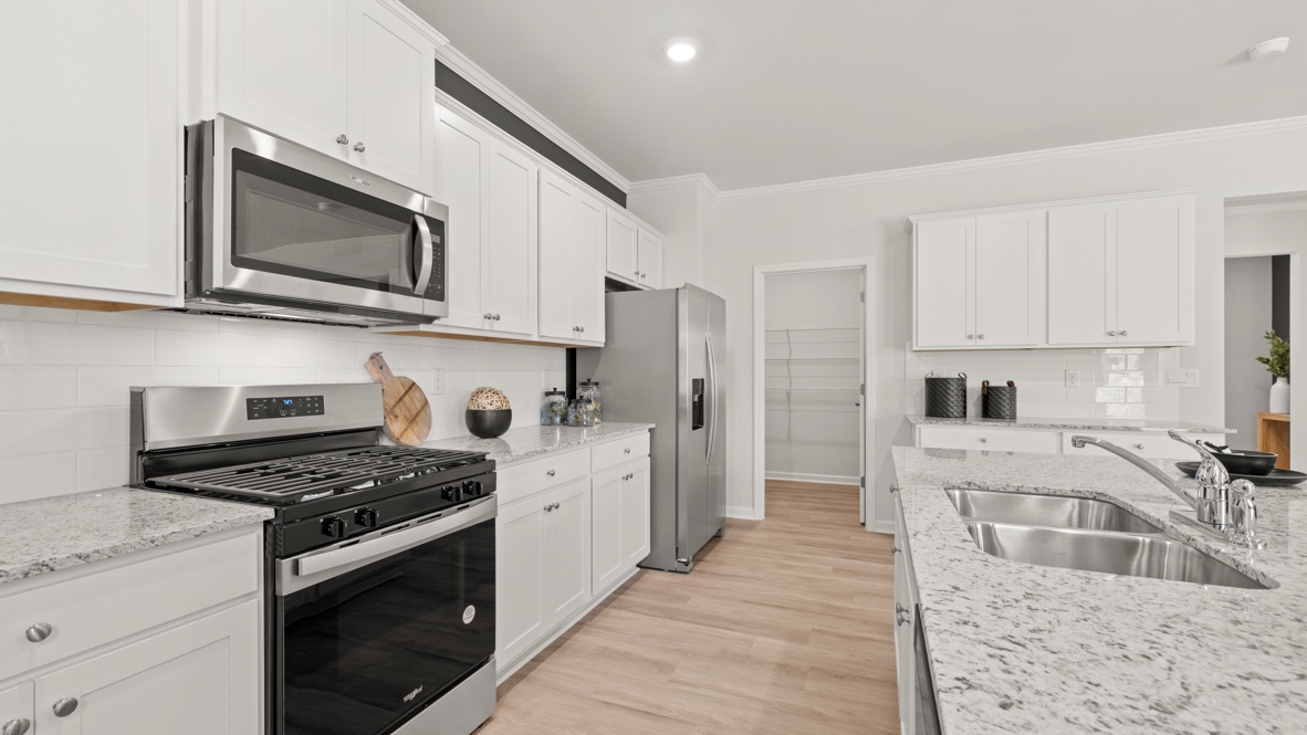 Interior kitchen with center island and white cabinets
