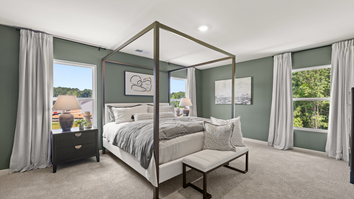 Interior bedroom with large windows and green accent walls