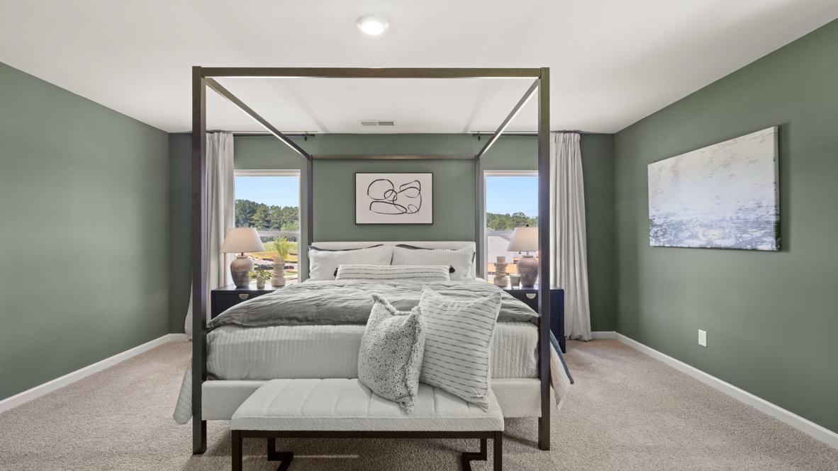Interior bedroom with large windows and green accent walls