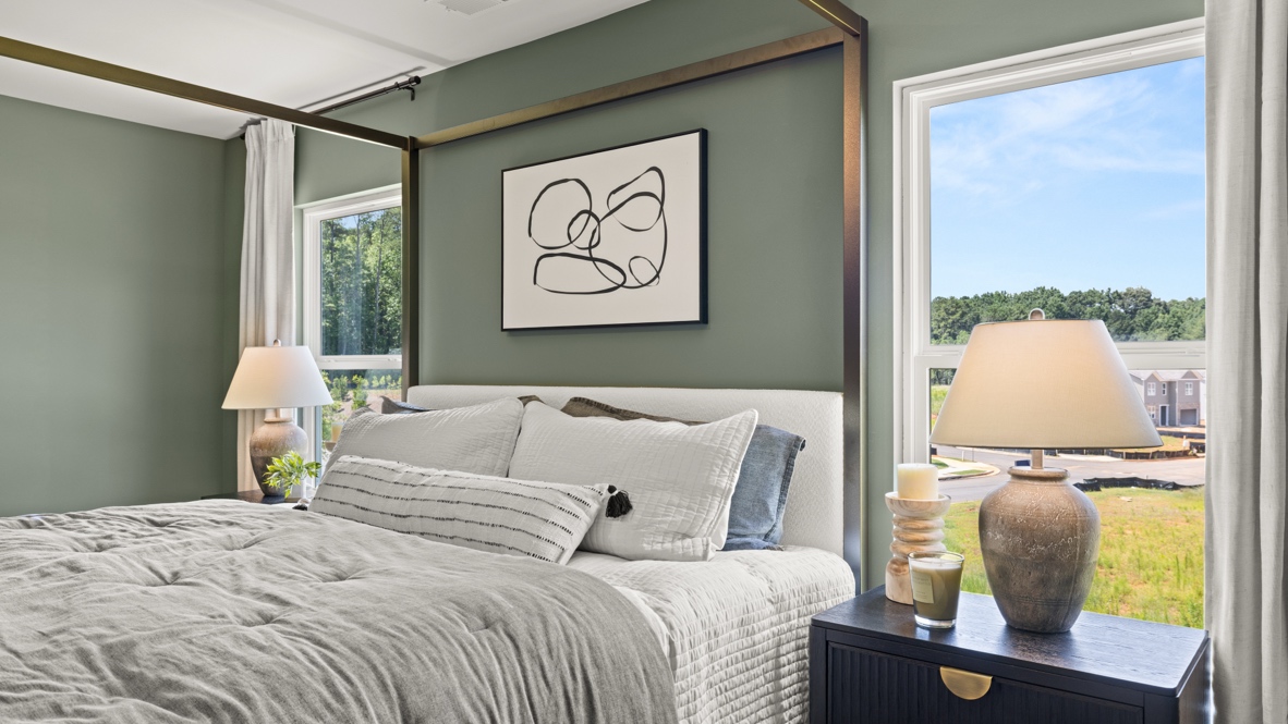 Interior bedroom with large windows and green accent walls