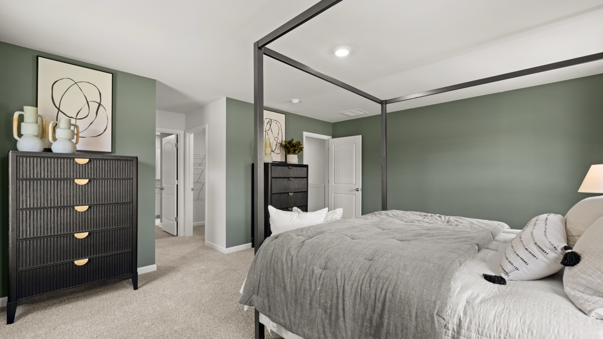 Interior bedroom with large windows and green accent walls