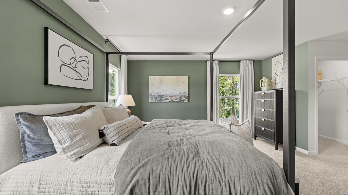 Interior bedroom with large windows and green accent walls