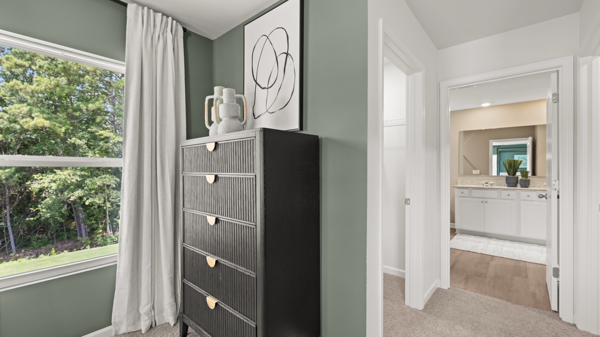 Interior bedroom with large windows and green accent walls
