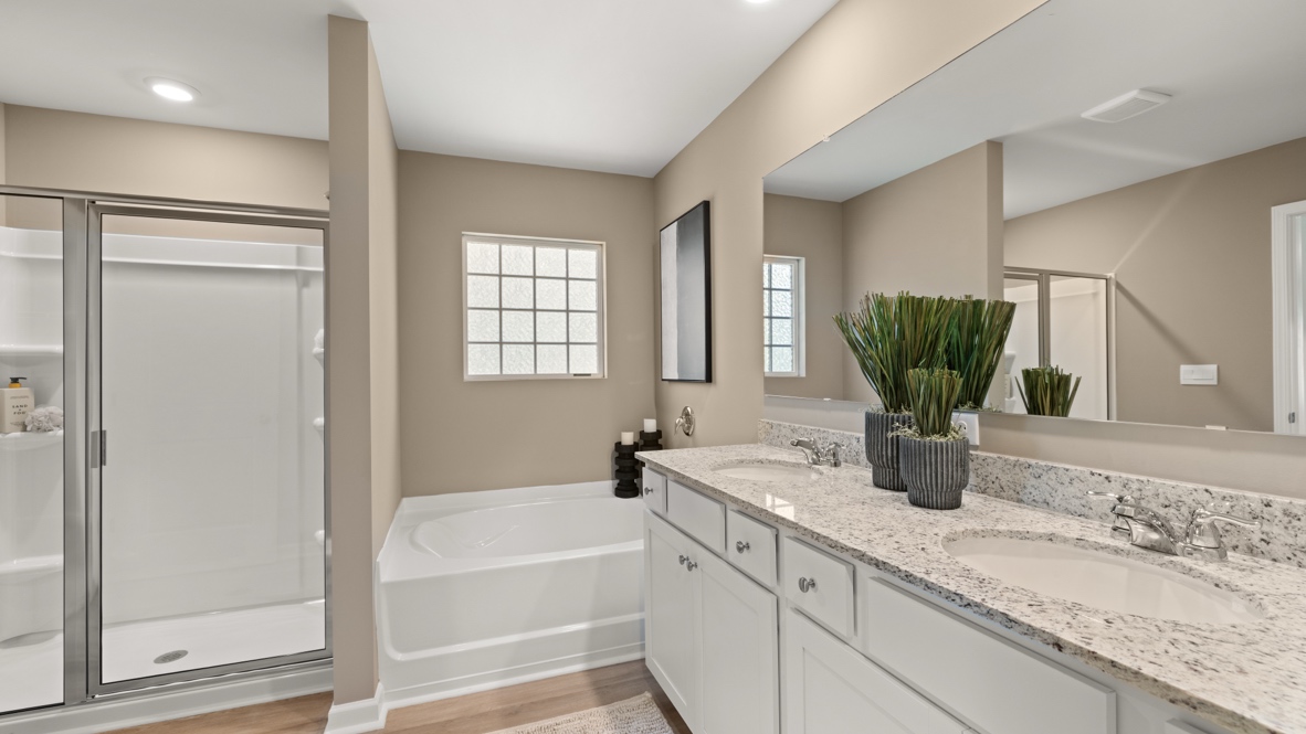 Interior bathroom with double sink, bath tub, and shower