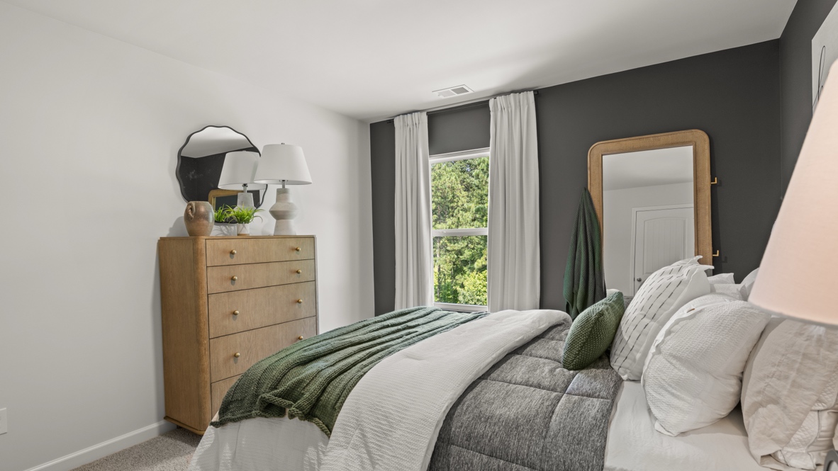 Interior bedroom with large window and dark grey accent wall