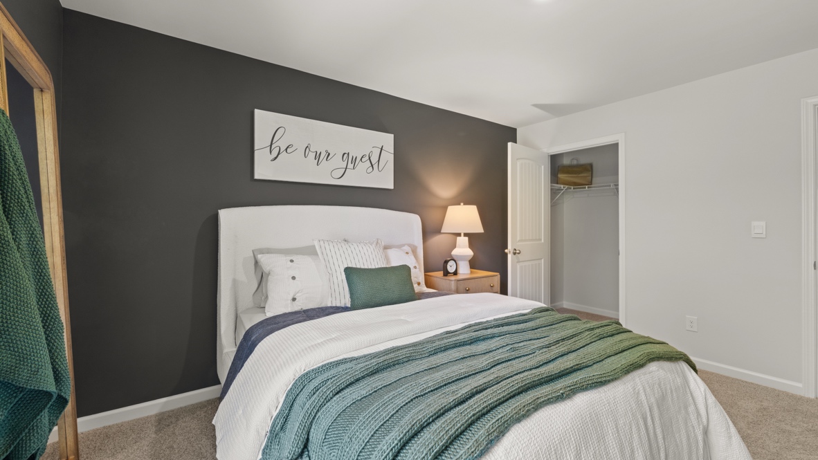 Interior bedroom with large window and dark grey accent wall