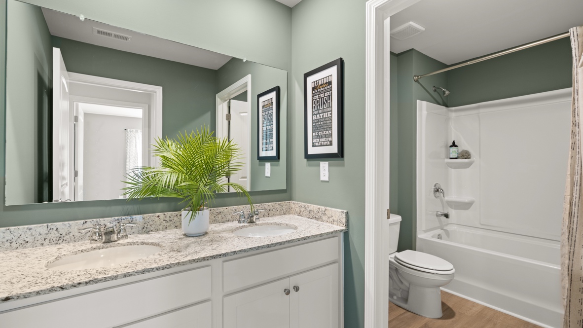 Interior bathroom with double sink and full-sized shower
