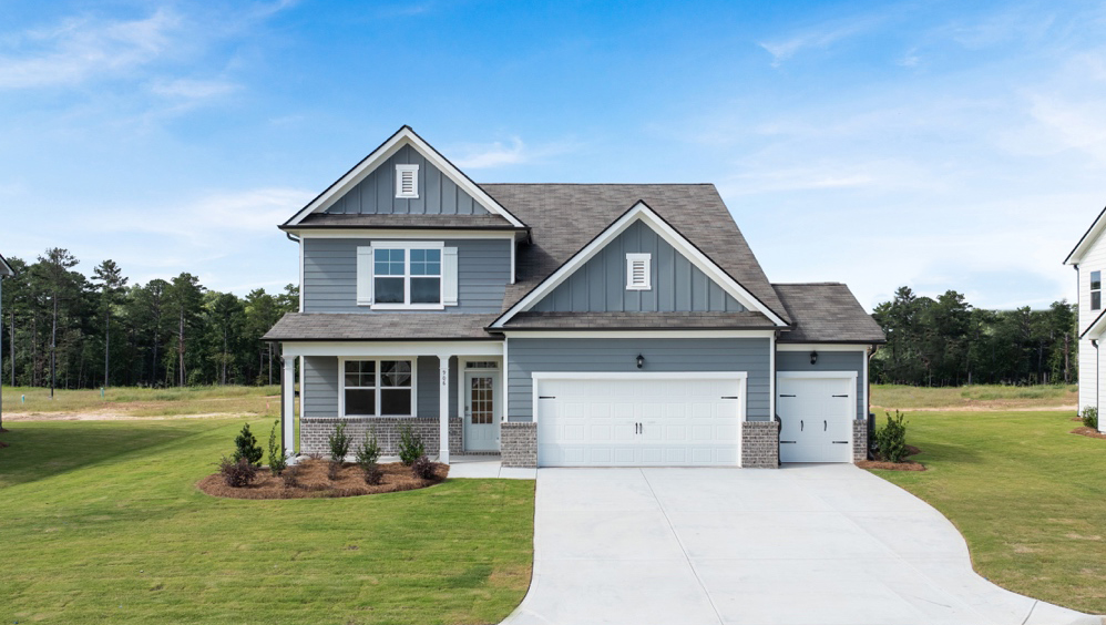 Exterior two-story home with cladding and stone detailing