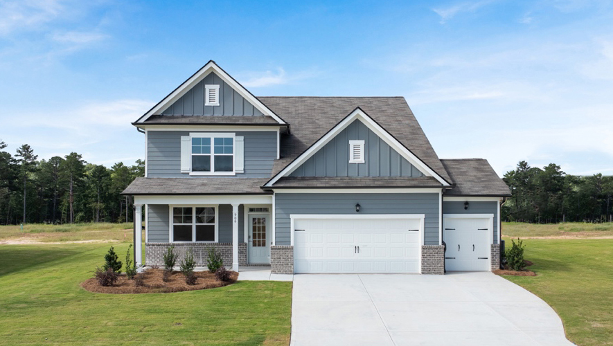 Exterior two-story home with cladding and stone detailing