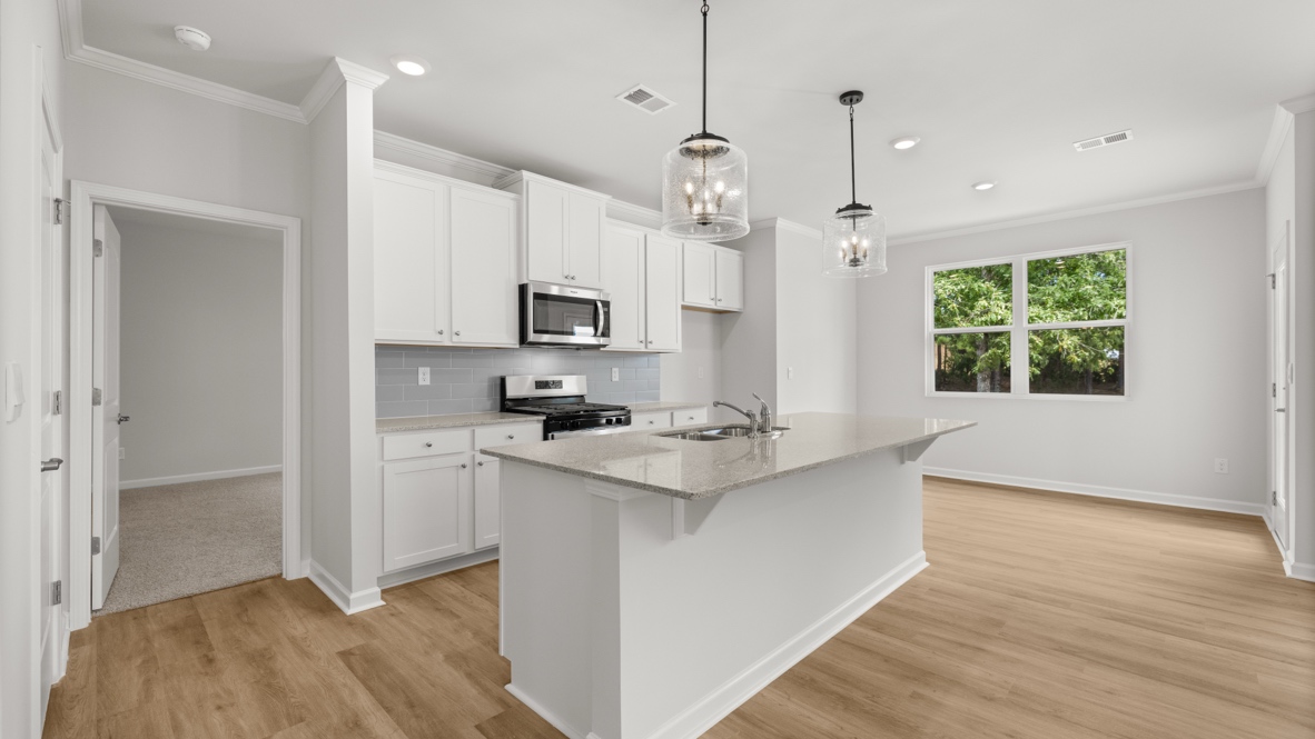 Interior kitchen with center island and white cabinets
